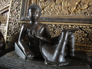 Statue of a reclining monk drinking tea